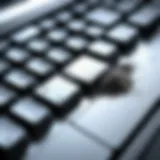 Close-up of a laptop keyboard showing dust and debris